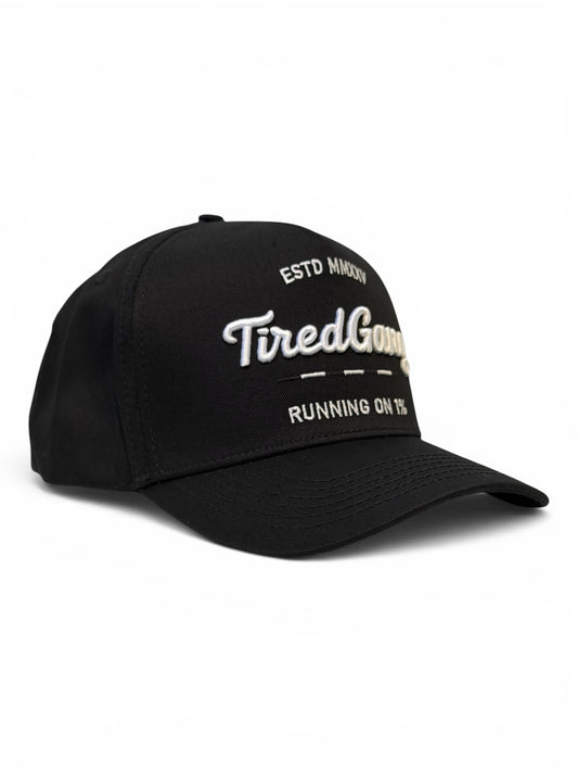 Side view of black cap with white embroidered text on a white background