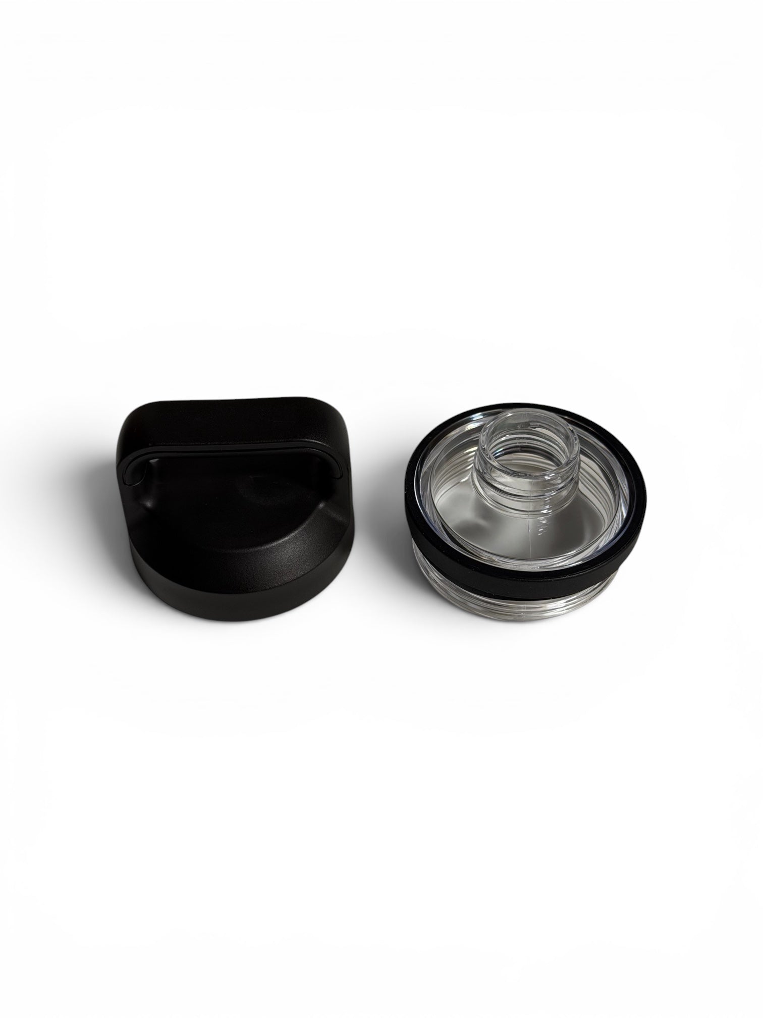 Black and clear plastic screw on lid components on a white background