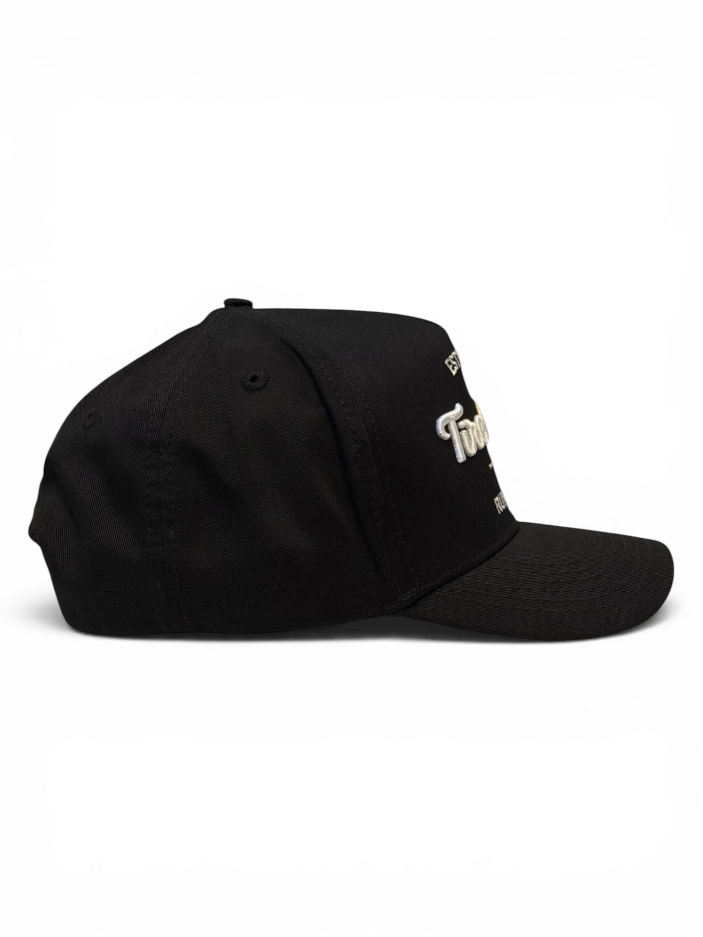 Side view of black cap with a white embroidered logo on a white background