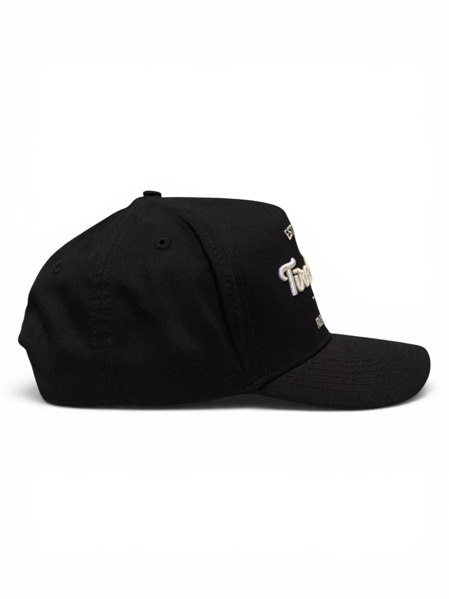 Side view of black cap with a white embroidered logo on a white background